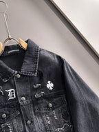 Dark denim jacket close-up with stand collar and embroidered chest patches