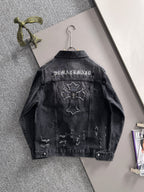 Dark denim jacket back view with embroidered lettering and distressed graphic patches