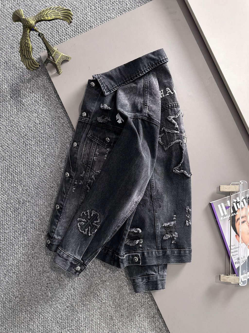 Dark denim jacket with button front and distressed embroidered graphics on back