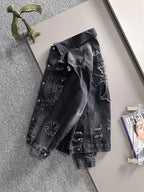 Dark denim jacket with button front and distressed embroidered graphics on back
