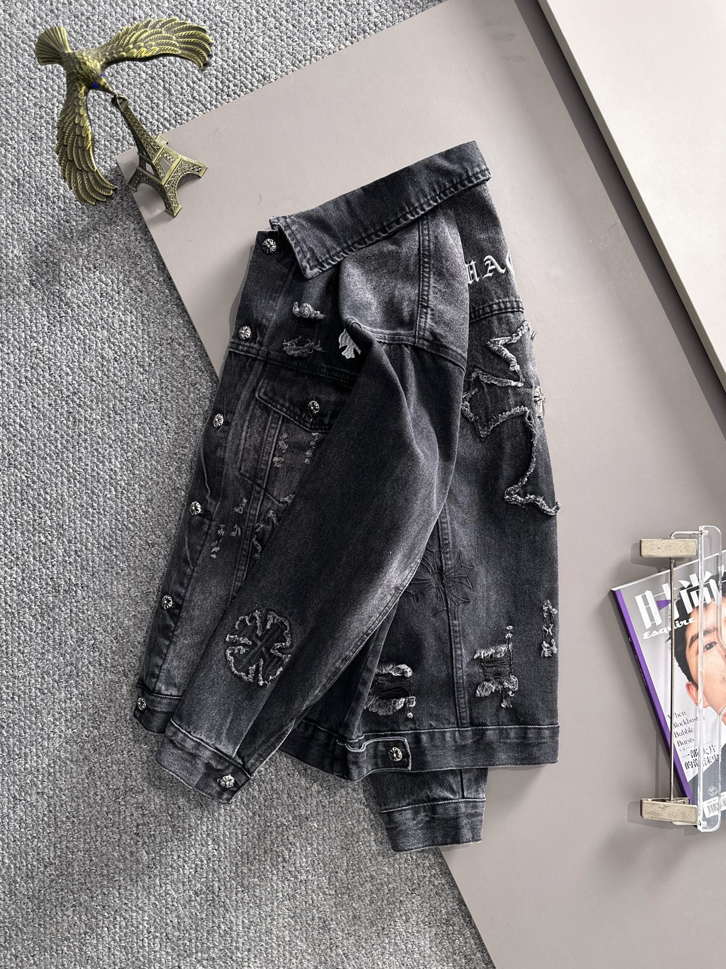 Dark denim jacket with button front and distressed embroidered graphics on back