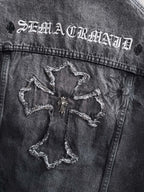 Dark denim jacket back yoke with embroidered star-like patches and worn stitching