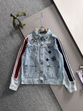 Light blue denim long-sleeve jacket with front button closure and embroidered patches
