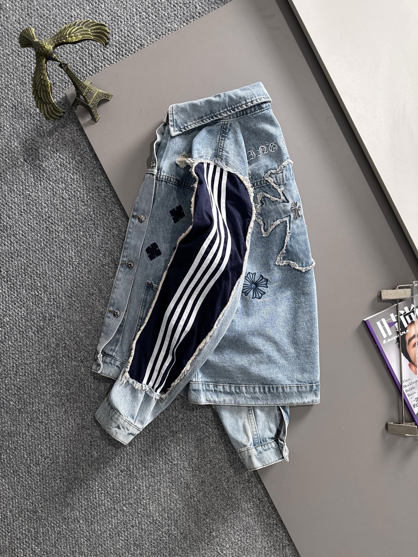 Light blue denim jacket back view with navy-and-white stripes and embroidered motifs