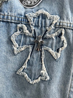 Light blue denim jacket with star-shaped embroidered cross appliqué on chest