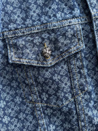 Blue patterned denim jacket with chest flap pocket and decorative flower button