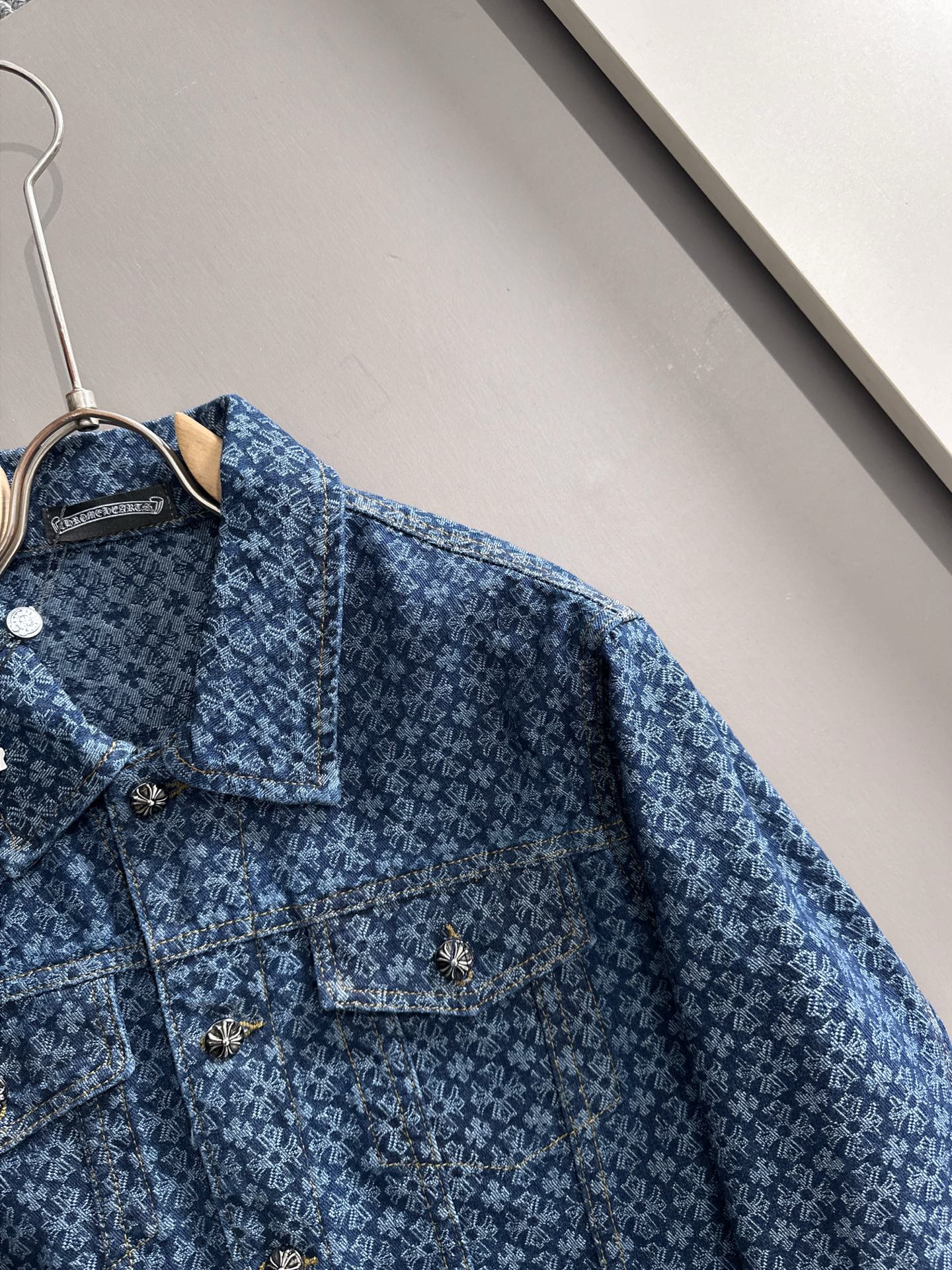Blue patterned denim jacket close-up of button placket and folded collar
