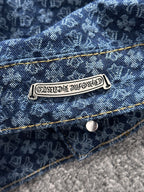 Blue denim jacket label on chest pocket, gold topstitching and button closure