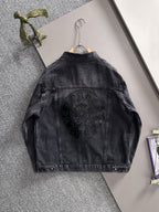 Dark denim jacket back view on hanger with large circular studded emblem