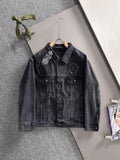 Dark denim jacket with pointed collar, front pockets, and studded chest patches
