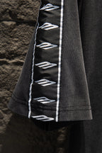 Balenciaga black T-shirt sleeve with vertical white logo tape