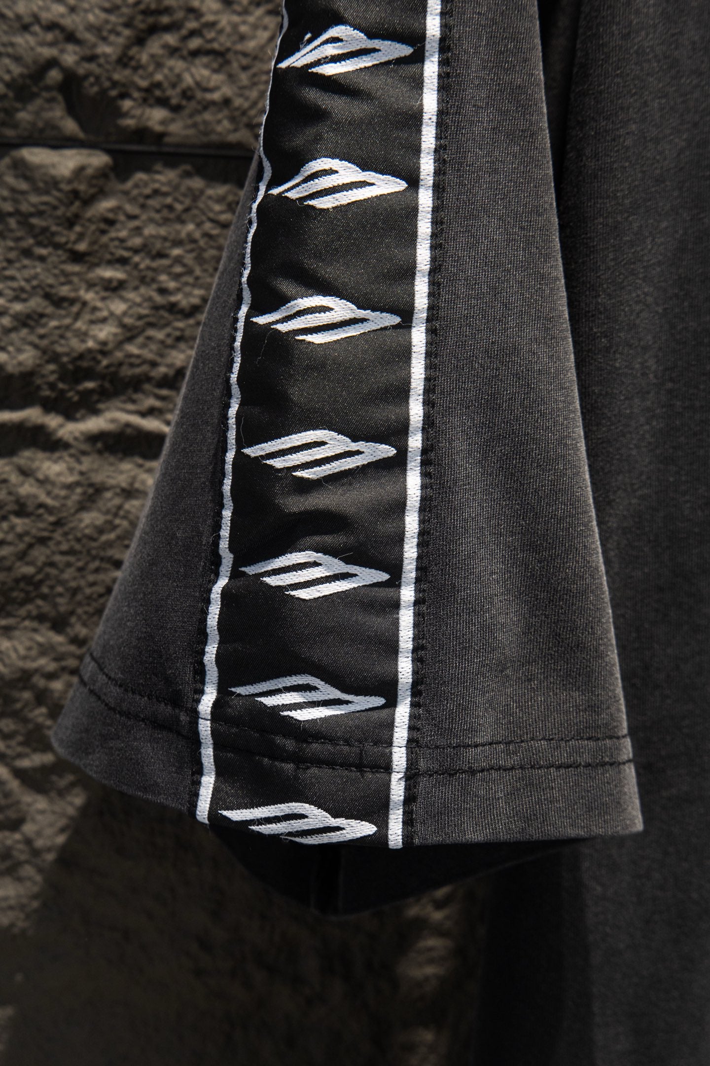 Balenciaga black T-shirt sleeve with vertical white logo tape