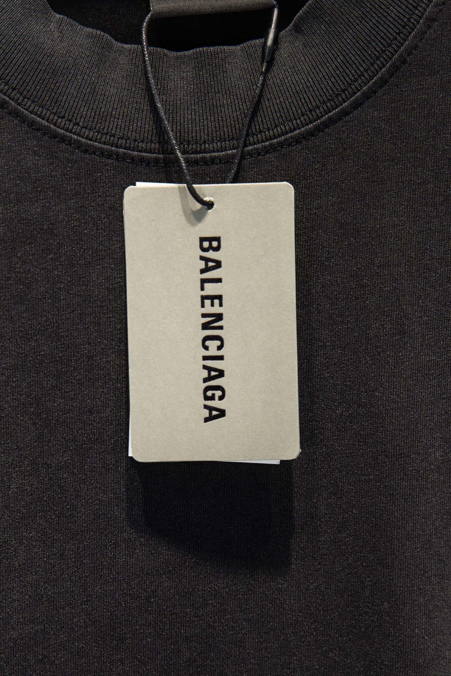 Balenciaga black T-shirt with hanging brand tag at neckline