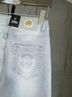 Light-wash denim jeans close-up of back pocket with embossed emblem