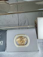Versace accessory tag with gold emblem and light blue leather card