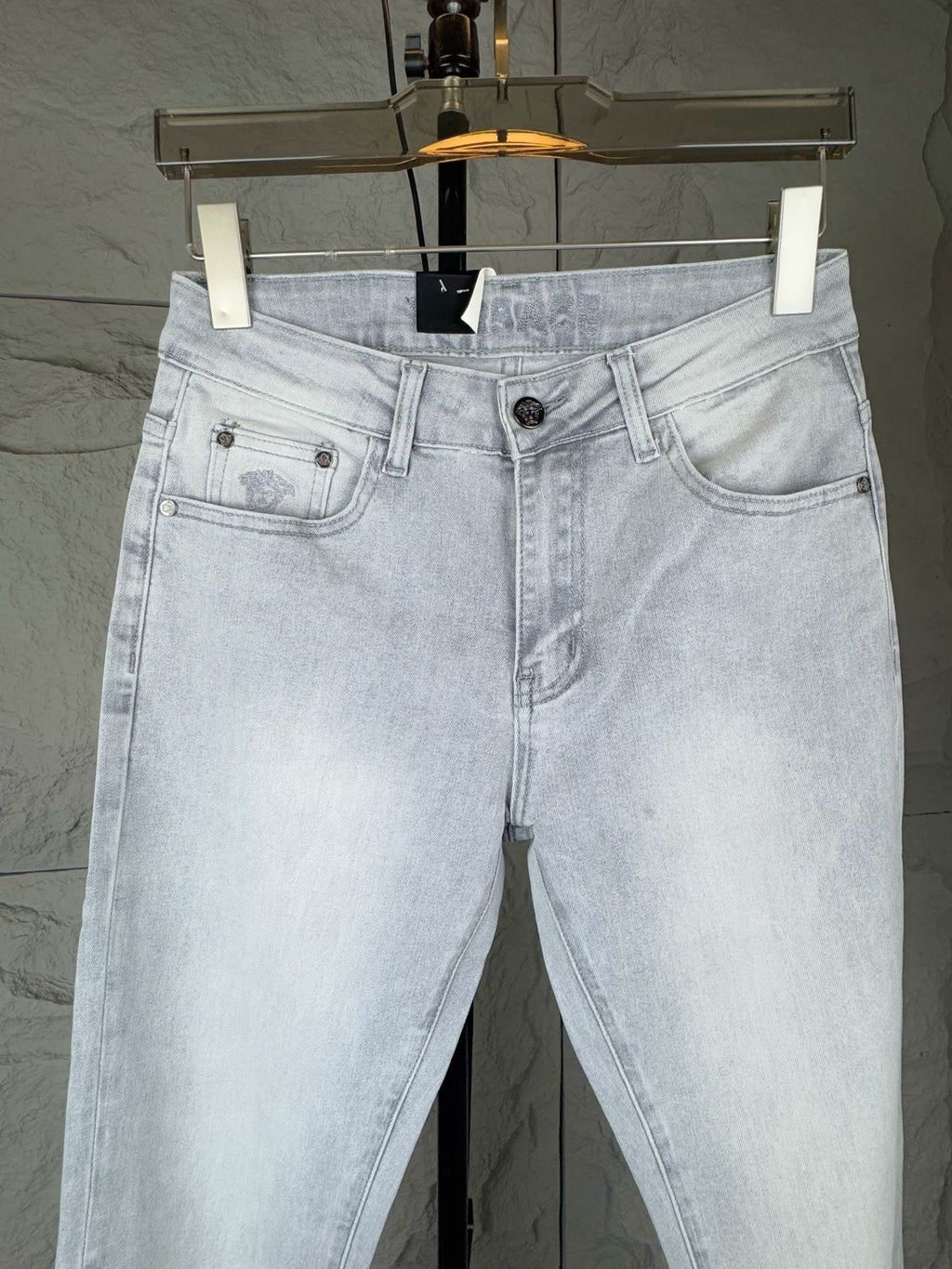 Light-wash denim jeans with front pockets, button fly, and belt loops