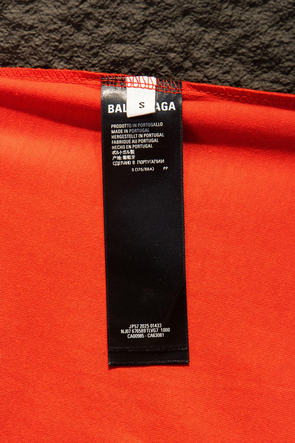 Balenciaga T-shirt care label with text on bright red fabric