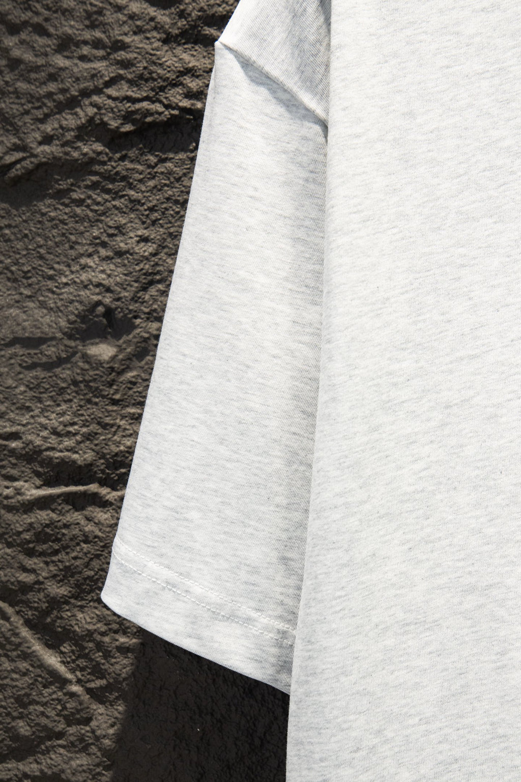 White T-shirt side panel with short sleeve hem, angled view