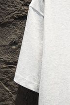 White T-shirt side panel with short sleeve hem, angled view