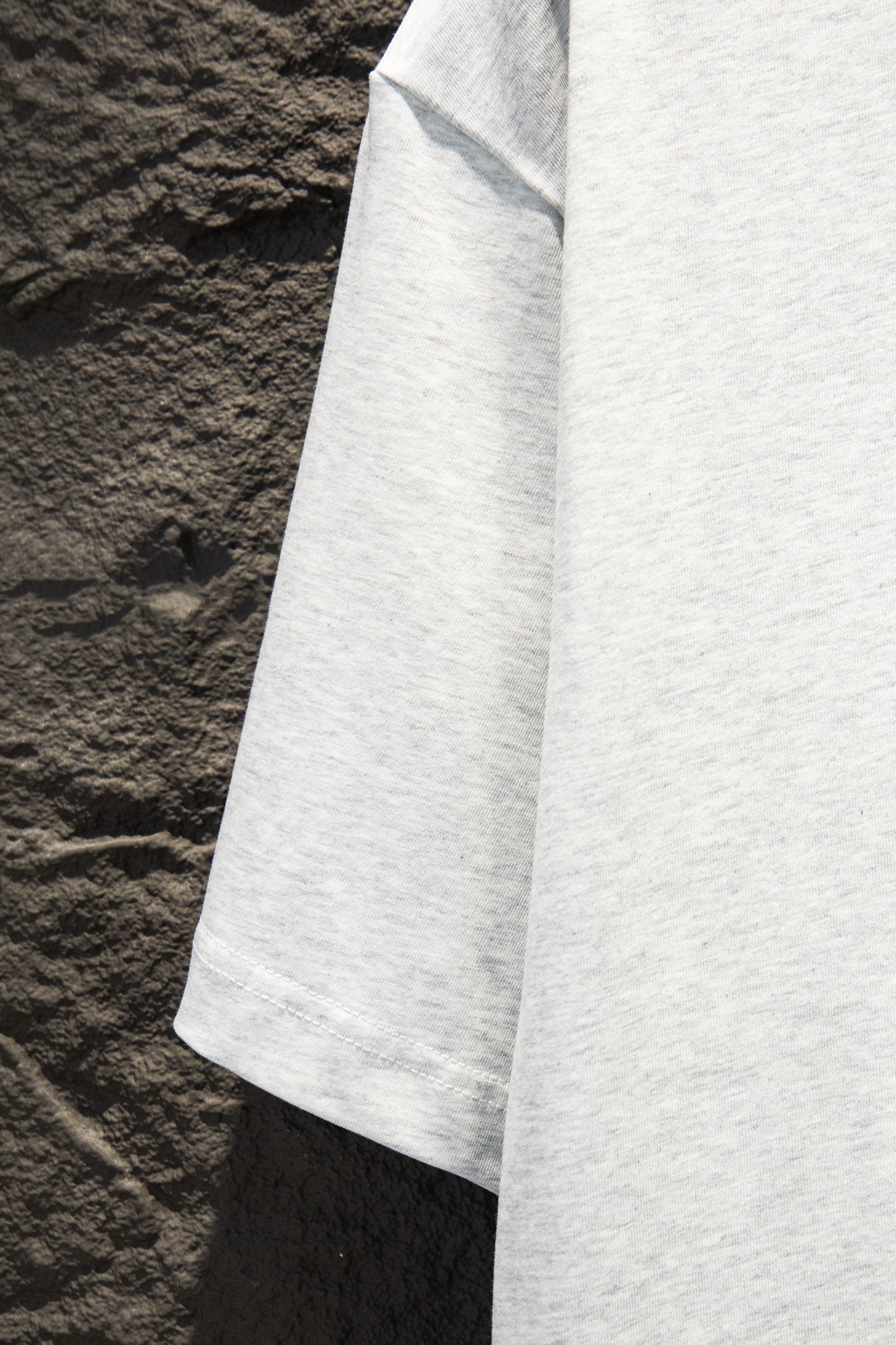 White T-shirt side panel with short sleeve hem, angled view