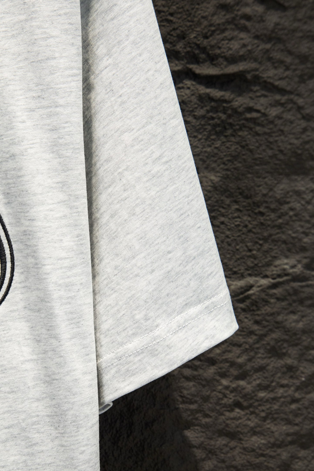 White T-shirt sleeve with neat hem, side view