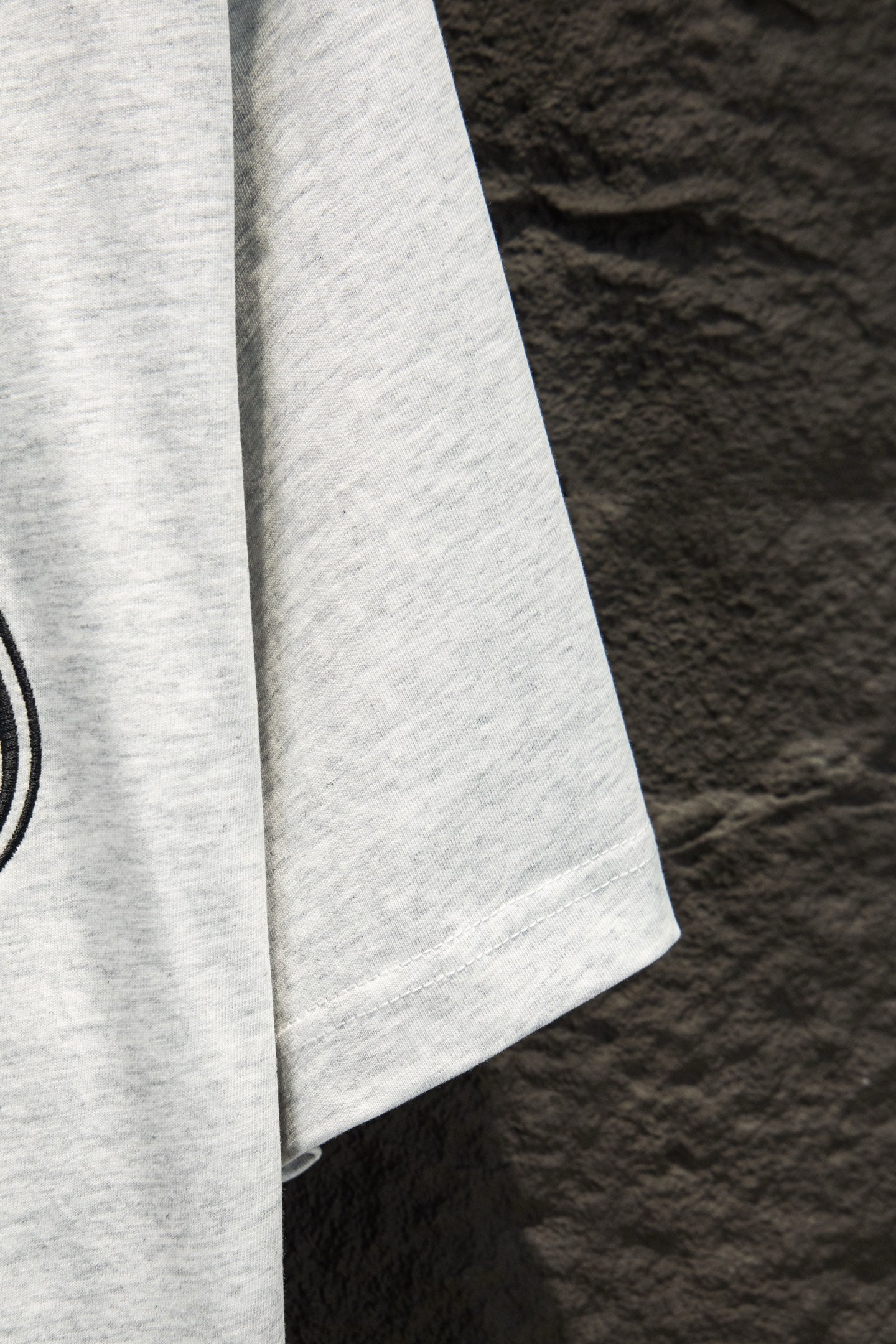White T-shirt sleeve with neat hem, side view
