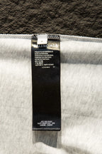 White T-shirt with black size and care label at top hem