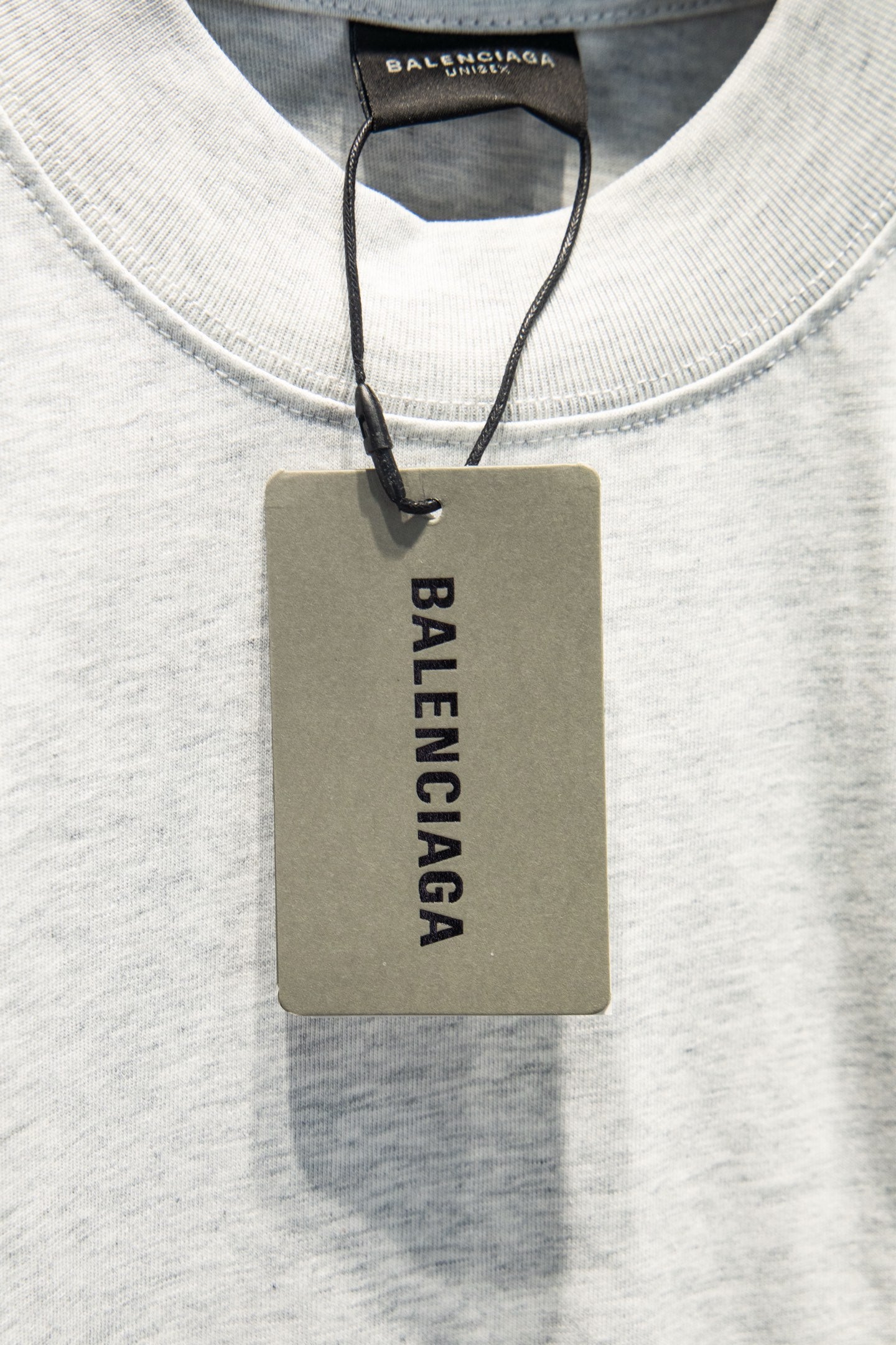 White crewneck T-shirt with Balenciaga hang tag at neckline