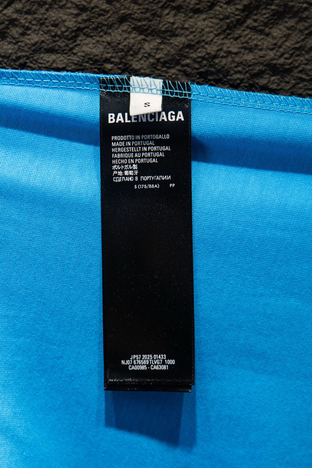 Balenciaga T-shirt care label inside collar on light blue fabric