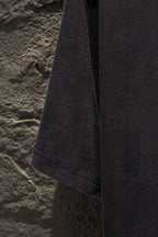 Black T-shirt side view with hem and sleeve opening