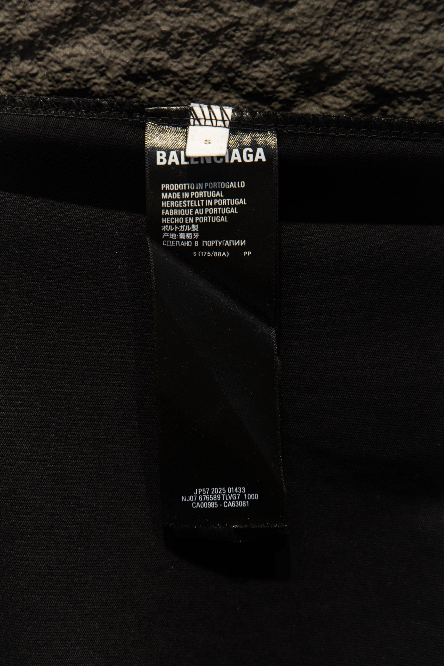 Balenciaga clothing care label on black fabric