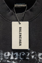 Black T-shirt with Balenciaga white size tag near collar