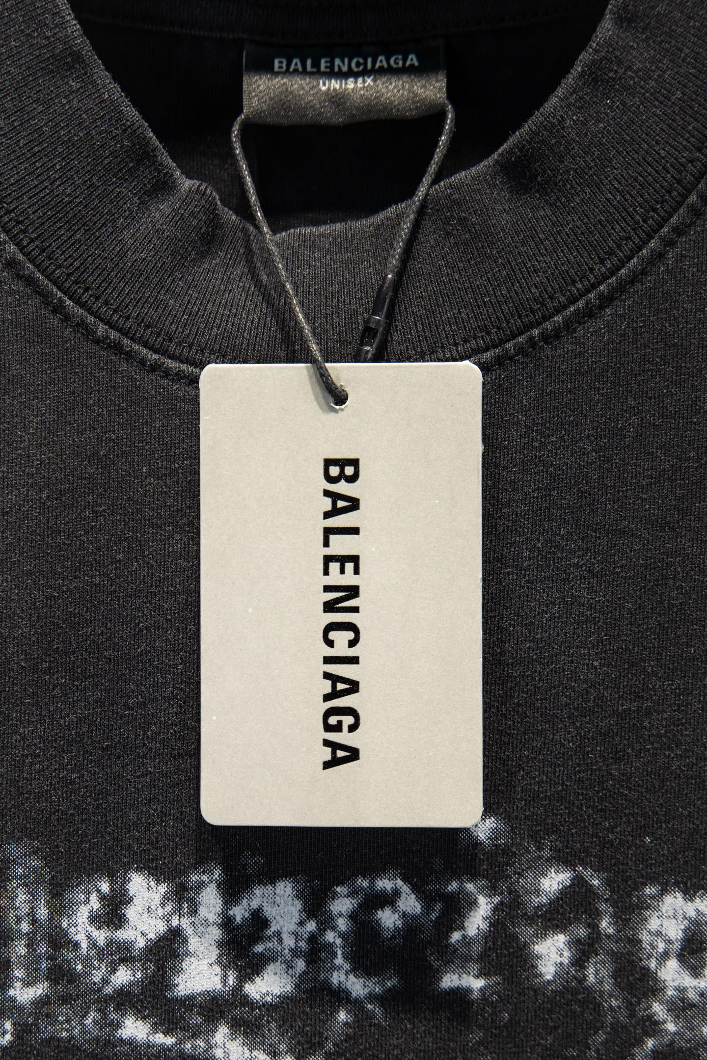 Black T-shirt with Balenciaga white size tag near collar