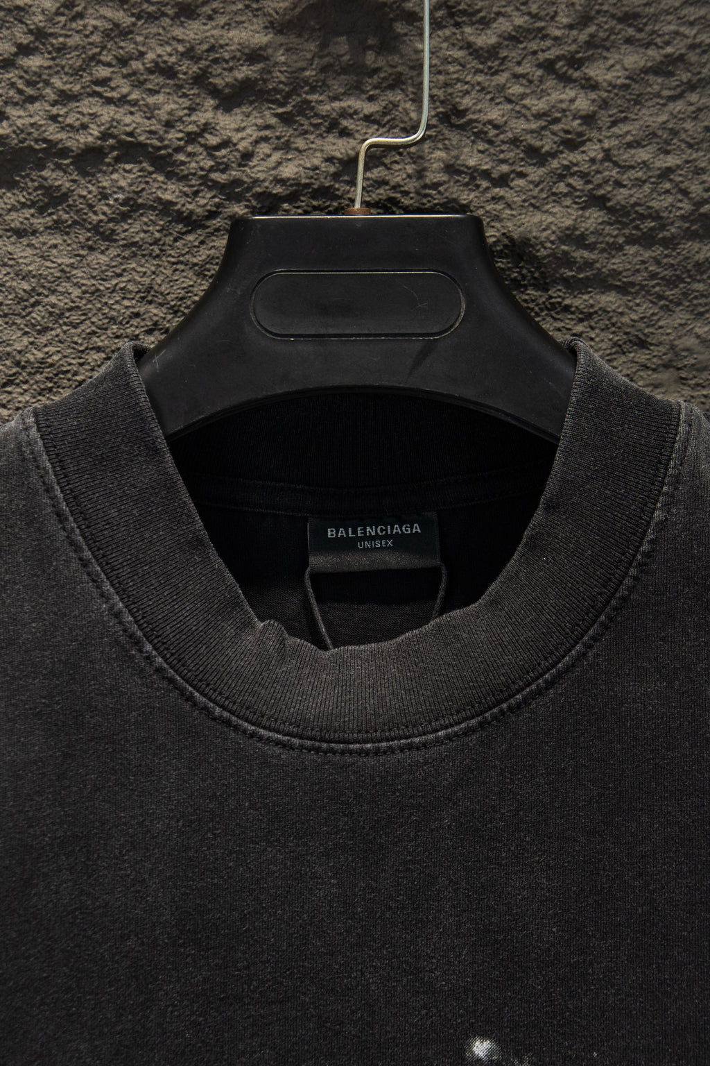 Black Balenciaga T-shirt collar and crew neckline close-up on hanger