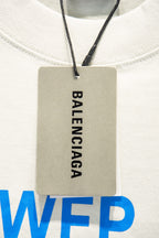 White T-shirt neckline with hanging BALENCIAGA label tag and blue WFP print
