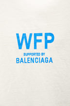 White T-shirt close-up with large blue WFP supported by BALENCIAGA text