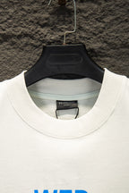White Balenciaga T-shirt collar with inner brand tag, hanging on hanger
