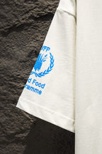 White T-shirt sleeve with blue laurel WFP text graphic