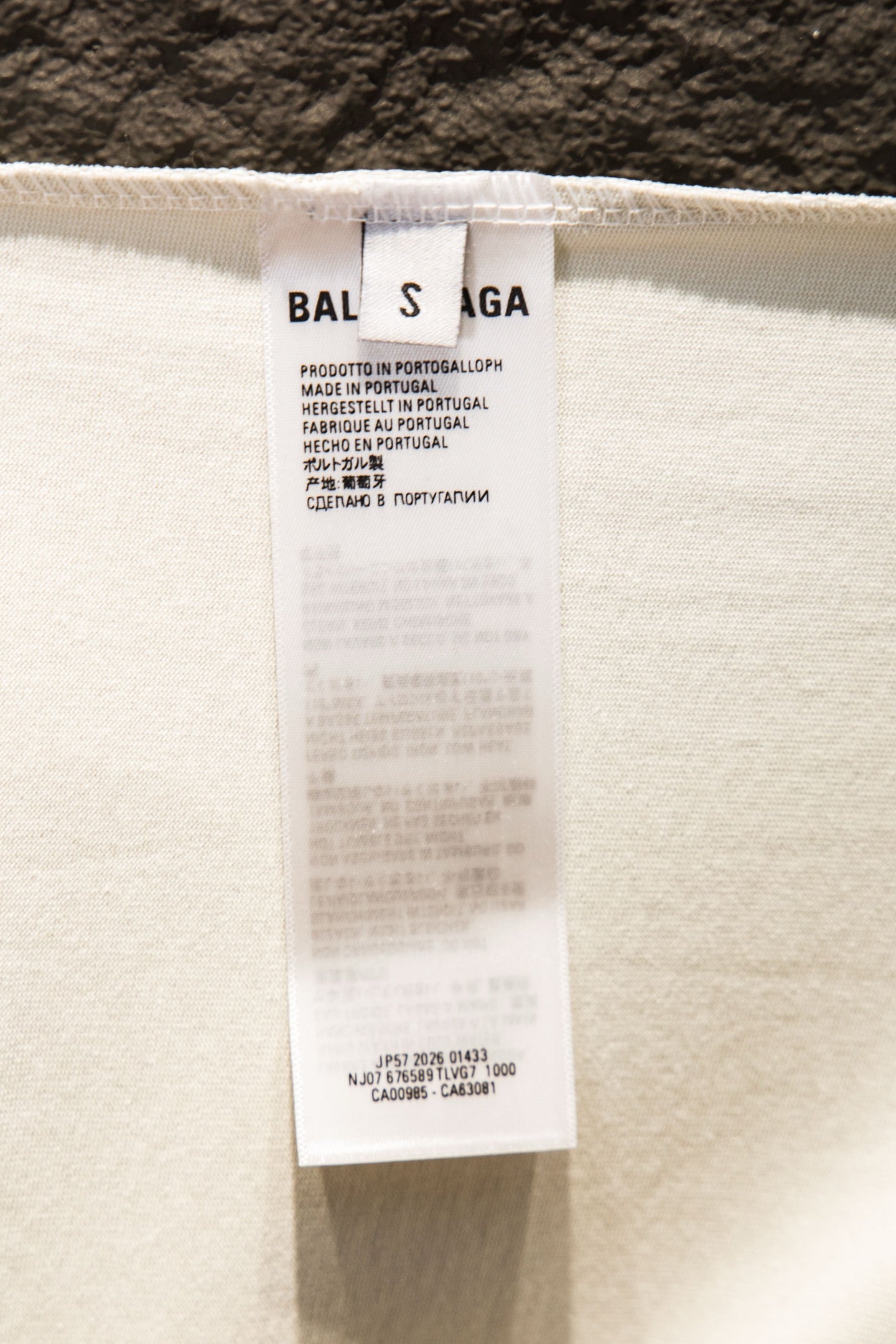 Balenciaga T-shirt inside care label on off-white fabric