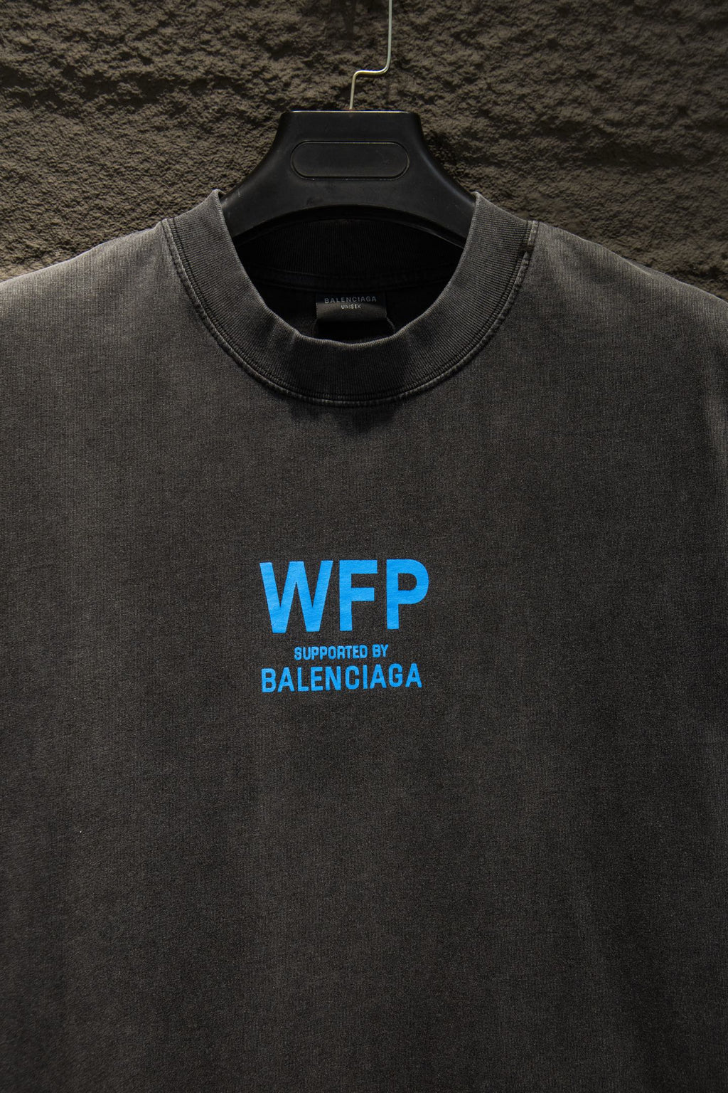 Gray short-sleeve T-shirt with blue “WFP” and “SUPPORTED BY BALENCIAGA”
