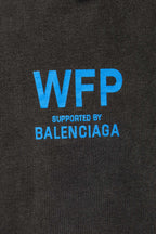 Gray T-shirt chest with large blue “WFP” and “SUPPORTED BY BALENCIAGA”
