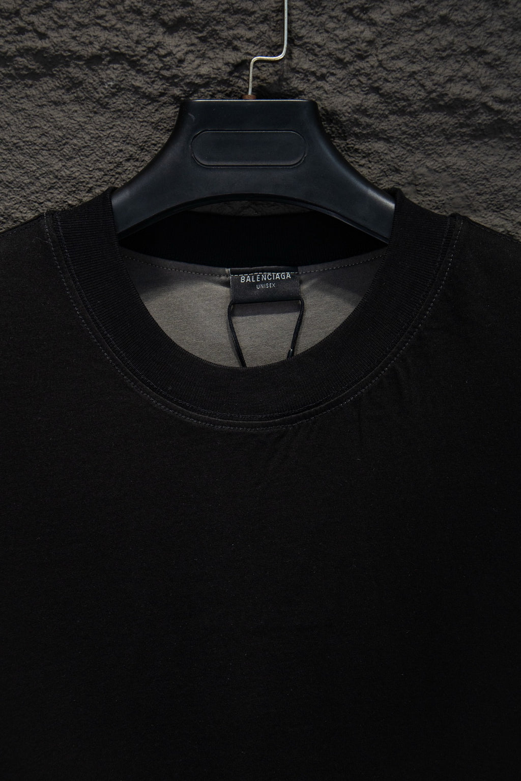 Balenciaga black T-shirt neckline close-up, ribbed crew neck