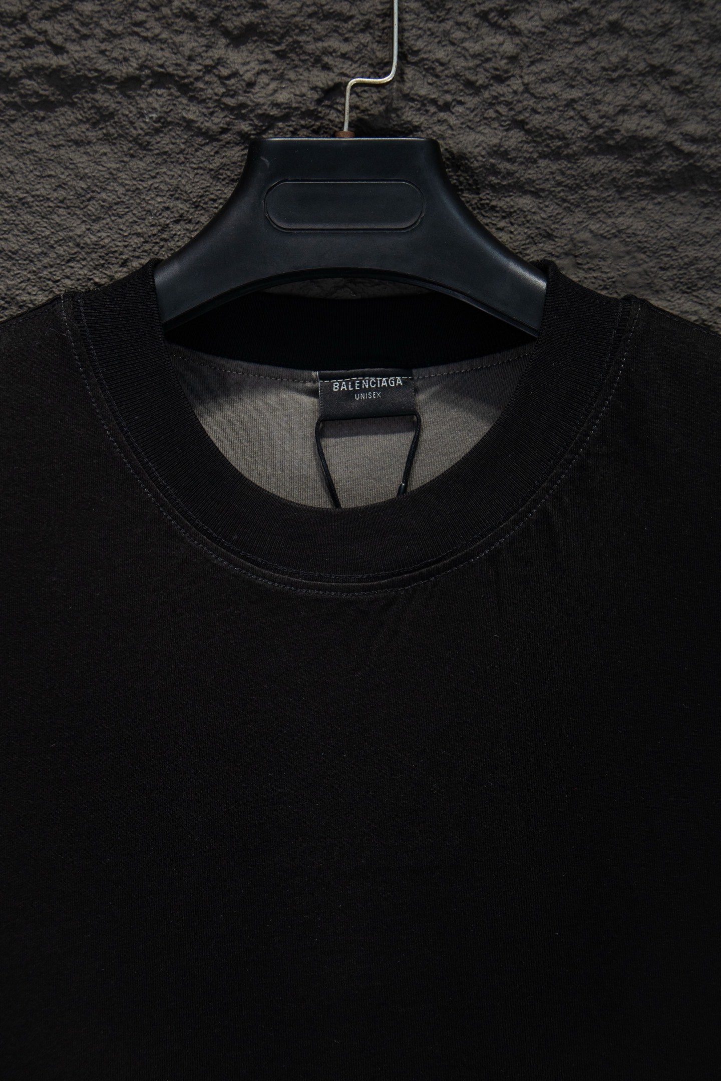 Balenciaga black T-shirt neckline close-up, ribbed crew neck