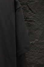Black short-sleeve T-shirt sleeve and shoulder seam detail