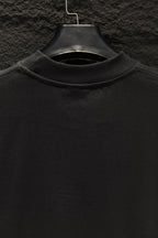 Black crewneck T-shirt collar on a hanger