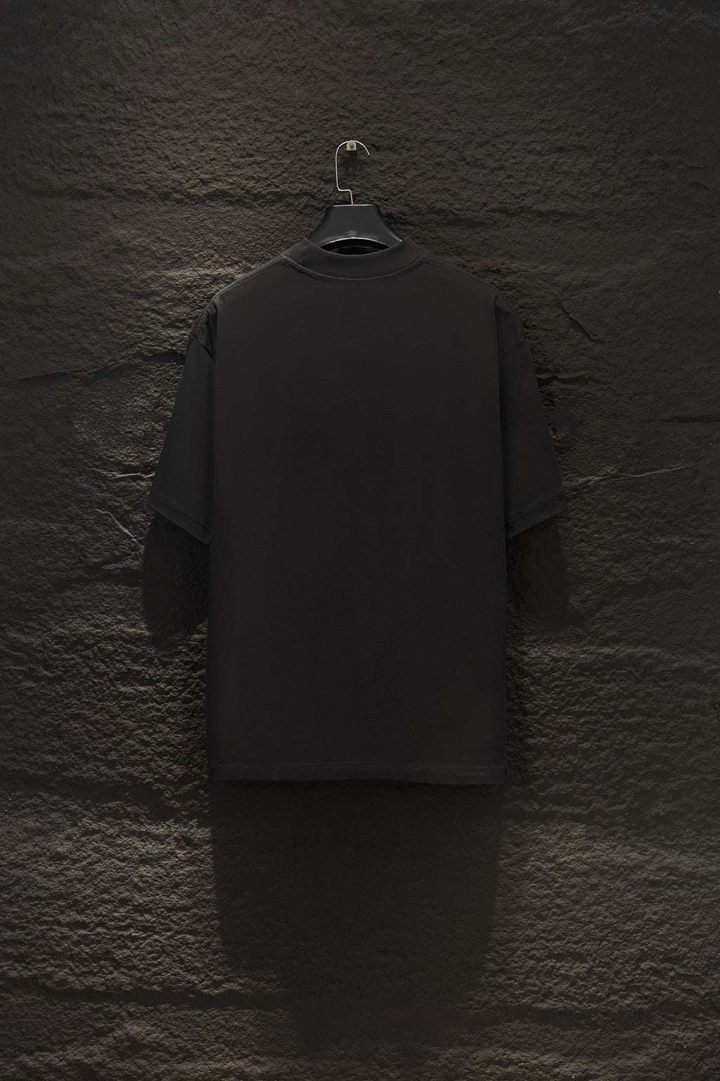Black short-sleeve T-shirt, back view on a hanger