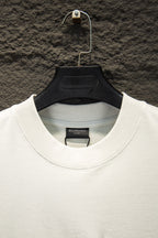 White crewneck T-shirt neckline with brand label inside collar