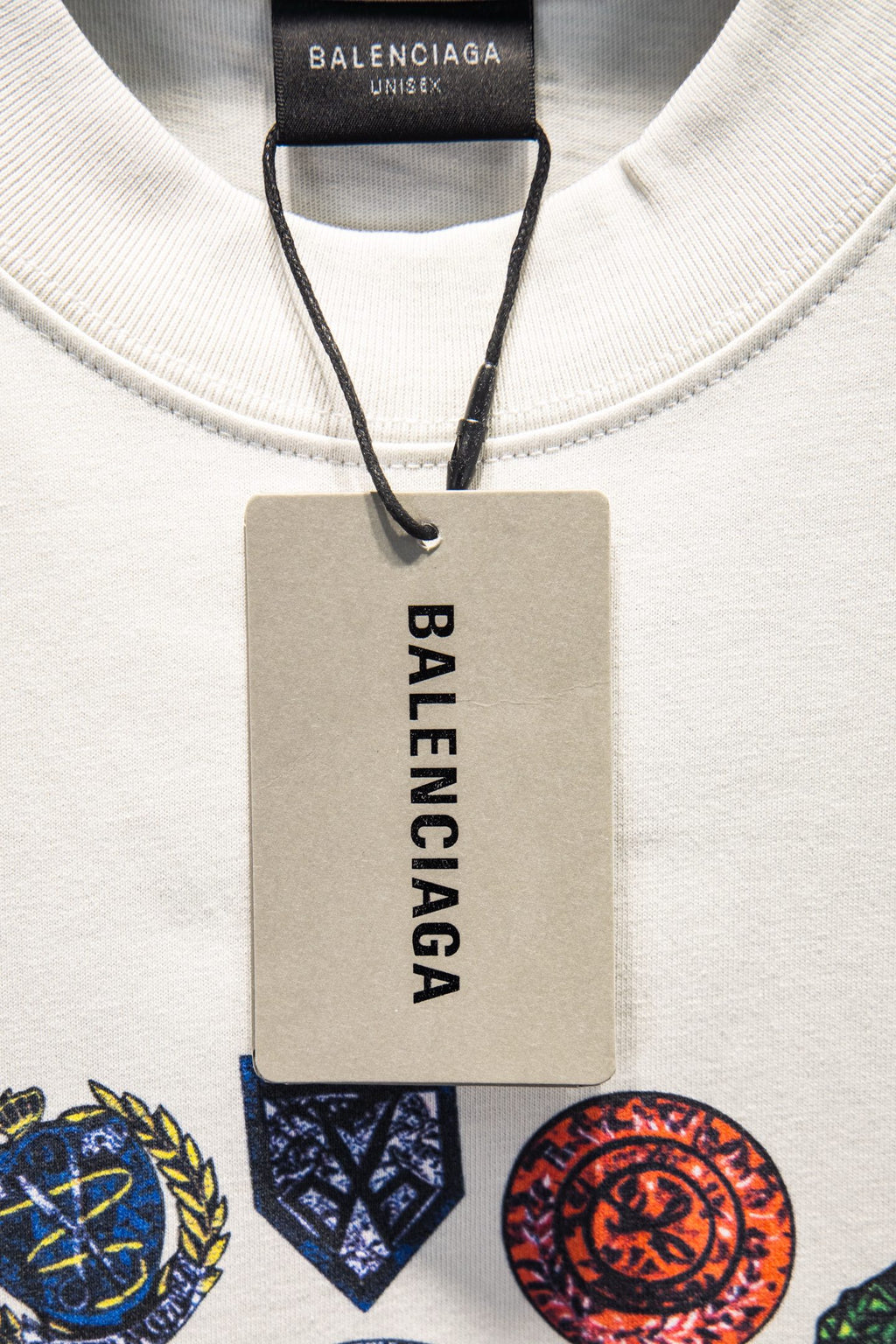 White Balenciaga T-shirt neckline with black brand label and attached size tag