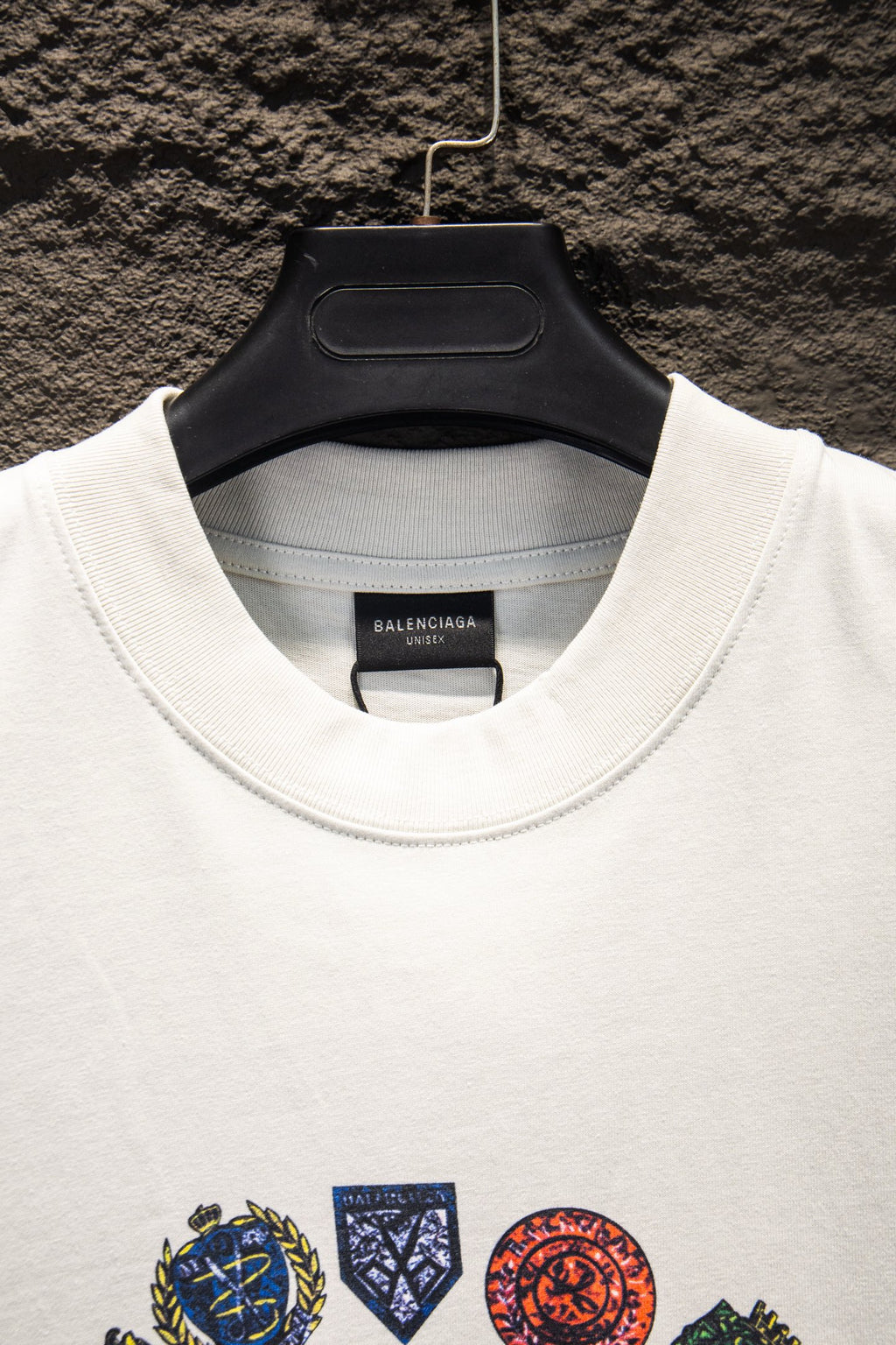 White Balenciaga T-shirt neckline with fabric tag and colorful emblem print