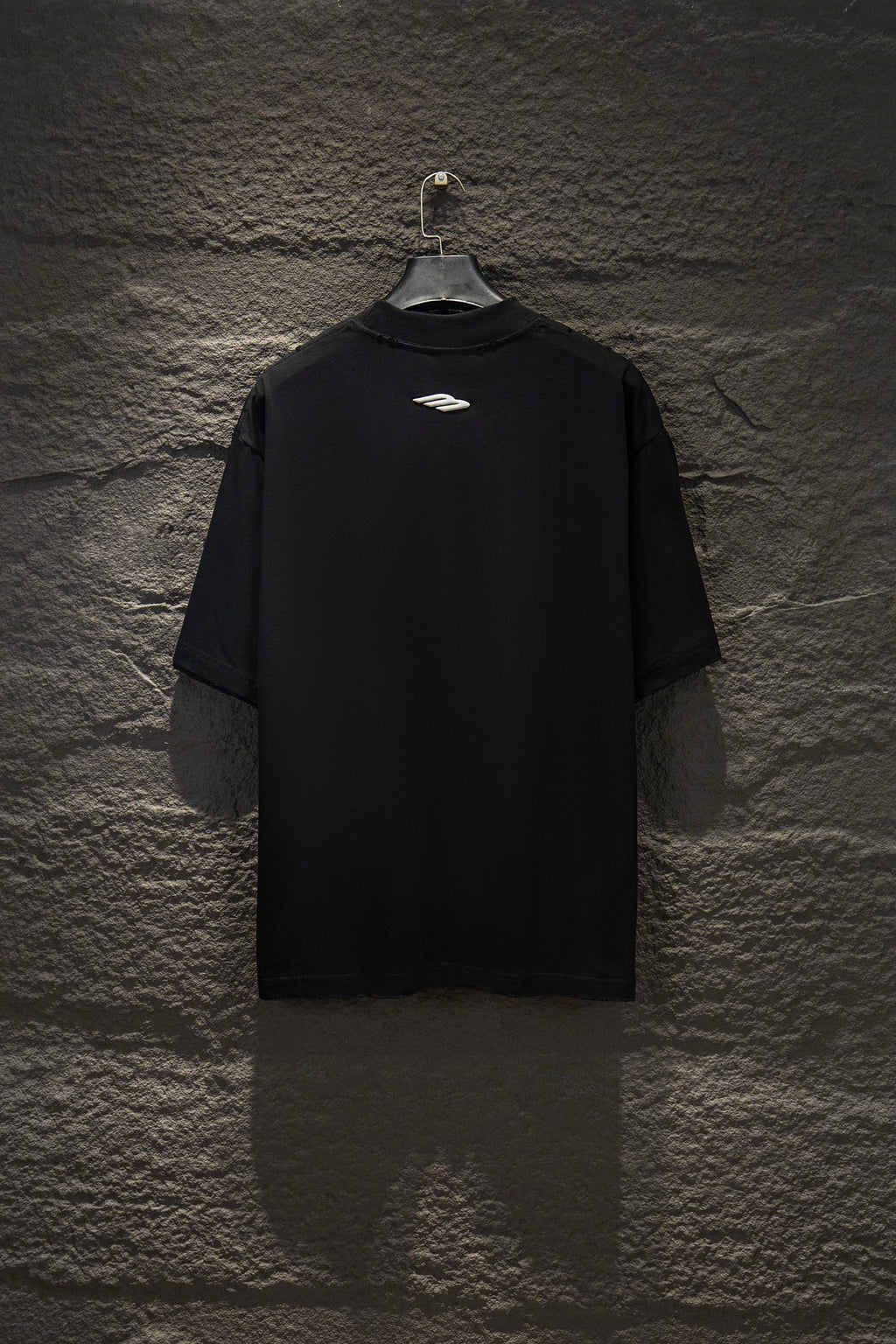 Black short-sleeve T-shirt with small chest logo on back.
